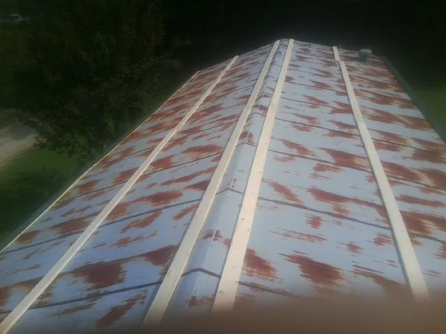 Rusted metal roof panels with new wood purlins before replacement — Storm Damage Roof Repair in Putnam Valley by Roofing Brothers