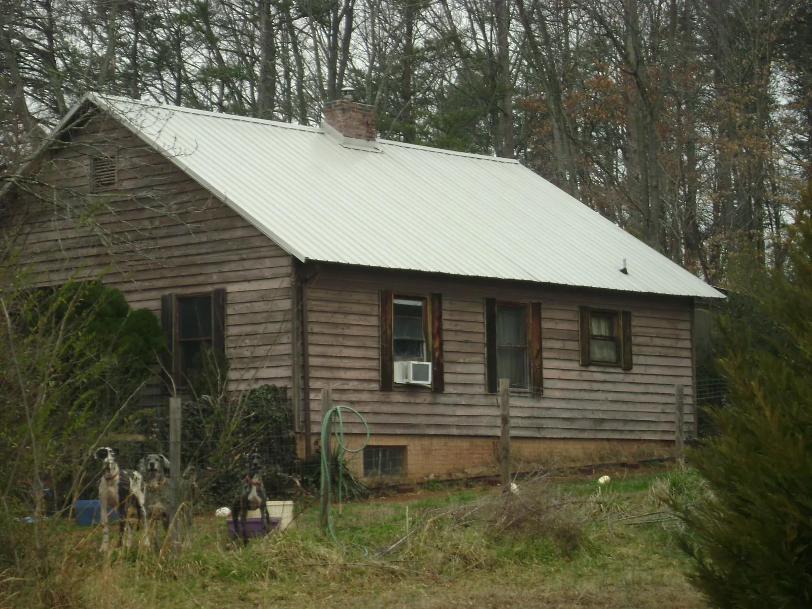 White metal roof on an old wood sided farmhouse, from a Metal Roof Installation job in Putnam Valley